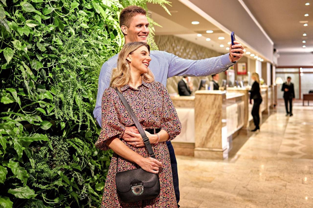 The Westin Zagreb Hotel Exterior photo A couple taking a photo together