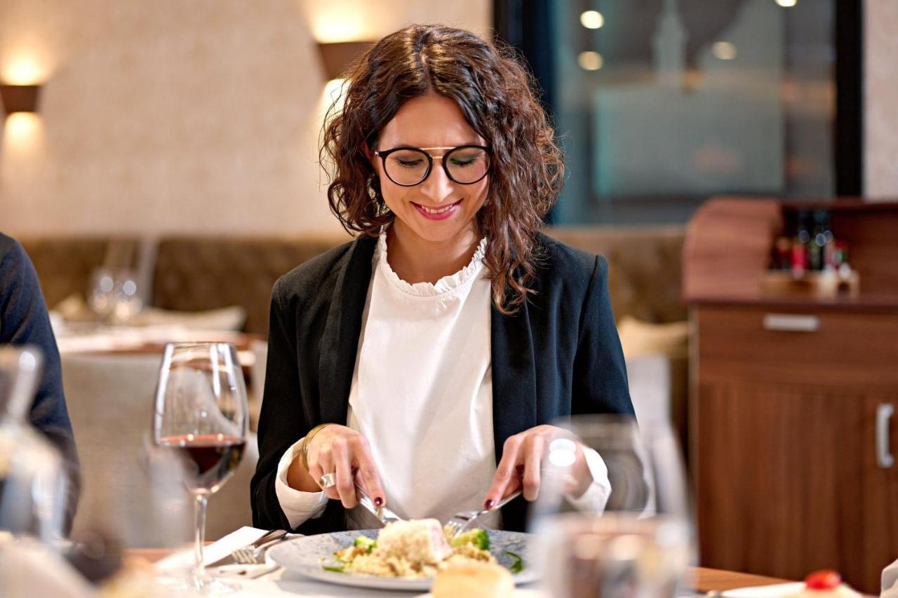 The Westin Zagreb Hotel Exterior photo A woman eating